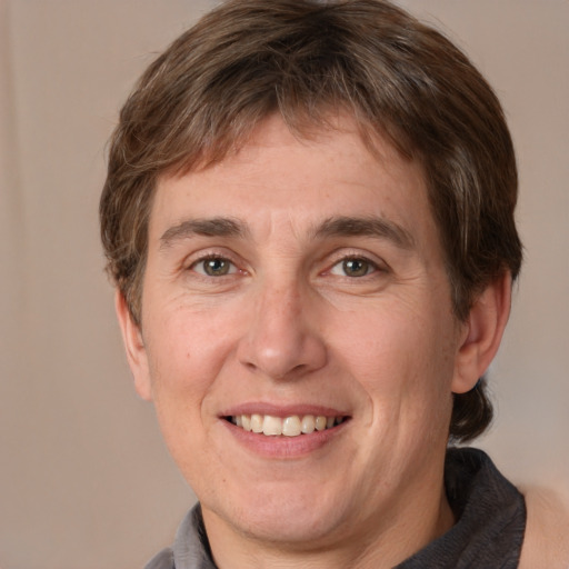 Joyful white adult male with medium  brown hair and brown eyes