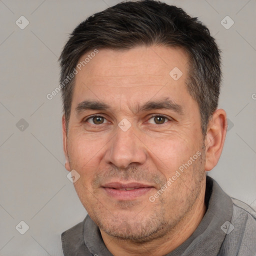 Joyful white adult male with short  brown hair and brown eyes