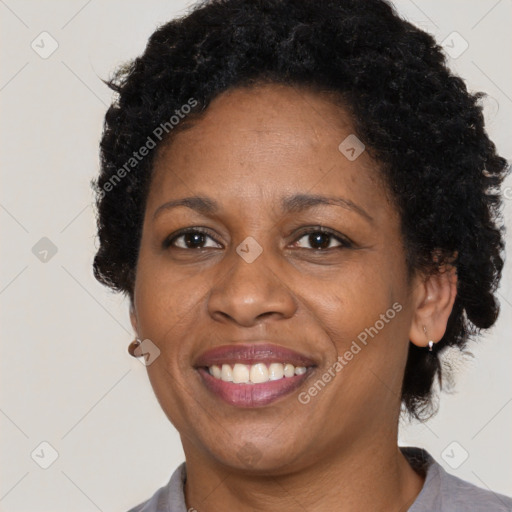 Joyful black adult female with short  brown hair and brown eyes