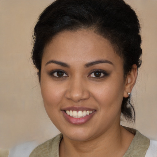 Joyful latino young-adult female with medium  brown hair and brown eyes