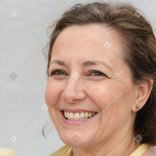 Joyful white adult female with medium  brown hair and brown eyes