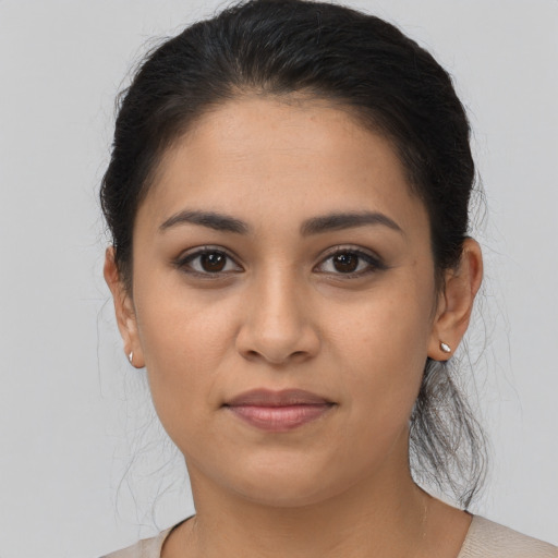 Joyful latino young-adult female with medium  black hair and brown eyes