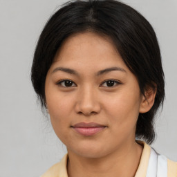 Joyful asian young-adult female with medium  brown hair and brown eyes