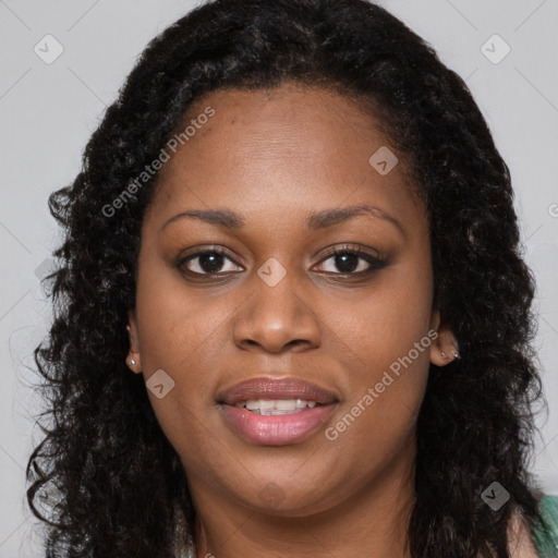 Joyful black young-adult female with long  brown hair and brown eyes