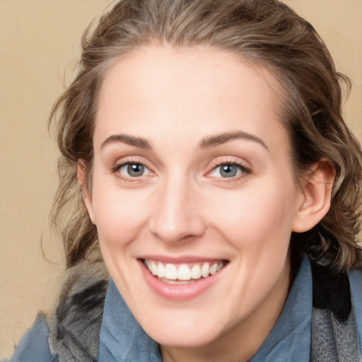 Joyful white young-adult female with medium  brown hair and blue eyes