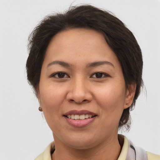 Joyful asian adult female with medium  brown hair and brown eyes