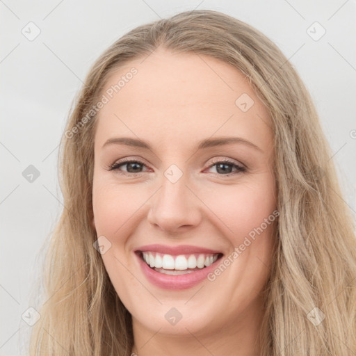 Joyful white young-adult female with long  brown hair and blue eyes