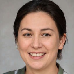 Joyful white adult female with medium  brown hair and brown eyes