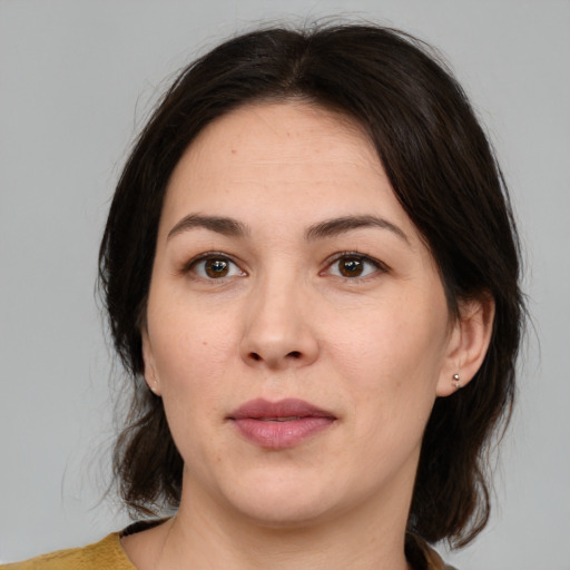 Joyful white adult female with medium  brown hair and brown eyes