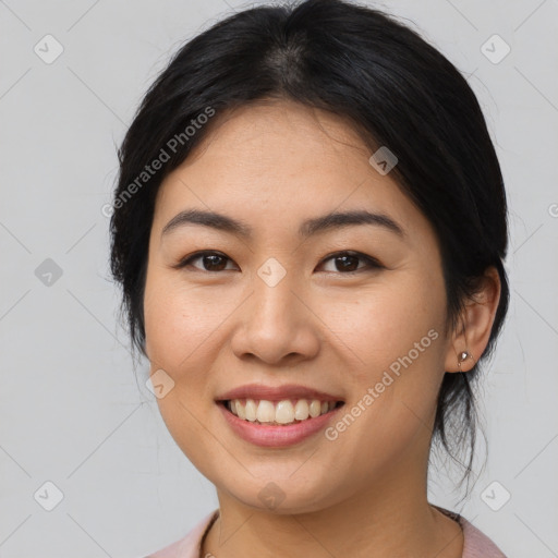 Joyful asian young-adult female with medium  brown hair and brown eyes