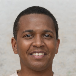 Joyful latino young-adult male with short  brown hair and brown eyes