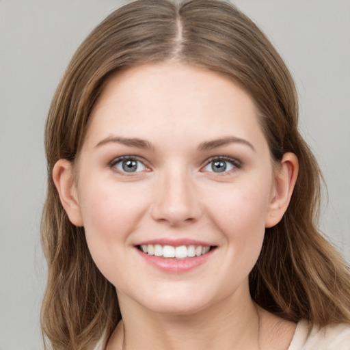 Joyful white young-adult female with long  brown hair and grey eyes