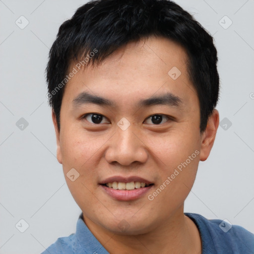 Joyful asian young-adult male with short  black hair and brown eyes