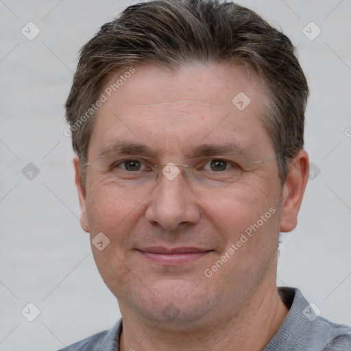 Joyful white adult male with short  brown hair and grey eyes