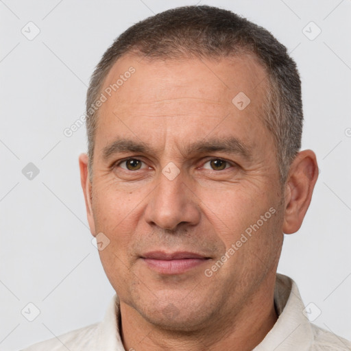 Joyful white adult male with short  brown hair and brown eyes