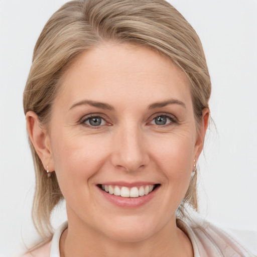 Joyful white young-adult female with medium  brown hair and blue eyes