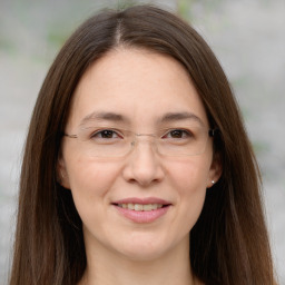 Joyful white adult female with long  brown hair and brown eyes