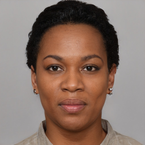 Joyful black young-adult female with short  black hair and brown eyes