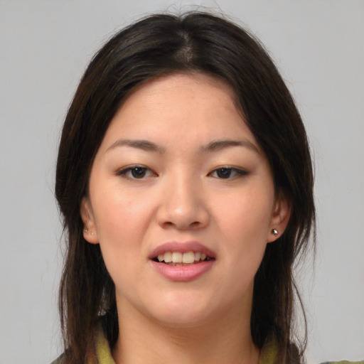 Joyful asian young-adult female with medium  brown hair and brown eyes