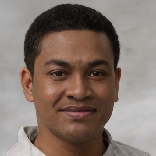Joyful latino young-adult male with short  brown hair and brown eyes