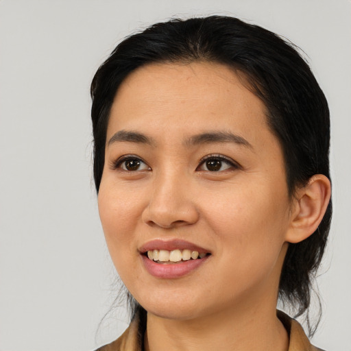 Joyful asian young-adult female with medium  black hair and brown eyes