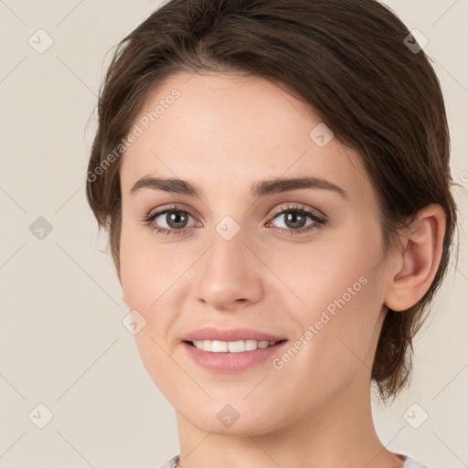 Joyful white young-adult female with medium  brown hair and green eyes