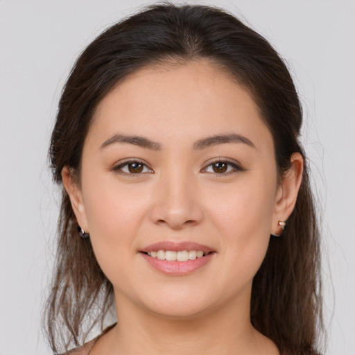 Joyful white young-adult female with long  brown hair and brown eyes