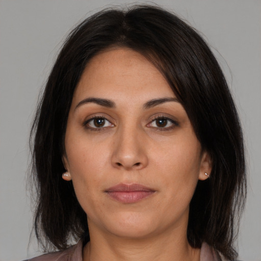 Neutral latino young-adult female with medium  brown hair and brown eyes