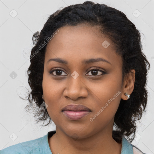 Joyful black young-adult female with long  black hair and brown eyes