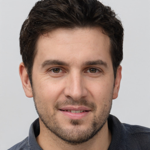 Joyful white young-adult male with short  brown hair and brown eyes