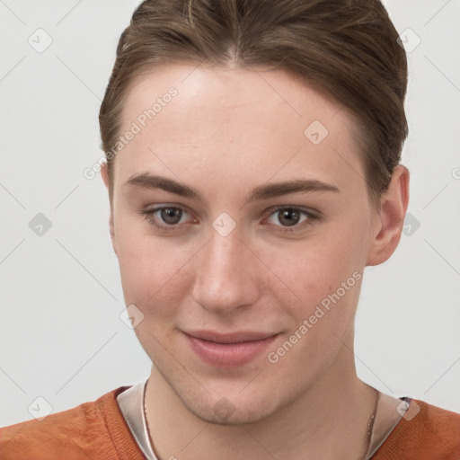 Joyful white young-adult female with short  brown hair and grey eyes