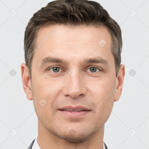 Joyful white adult male with short  brown hair and brown eyes