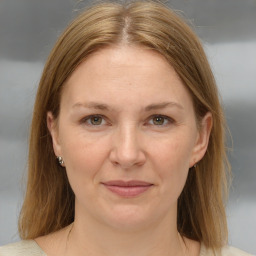 Joyful white adult female with medium  brown hair and brown eyes