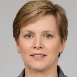 Joyful white adult female with medium  brown hair and grey eyes