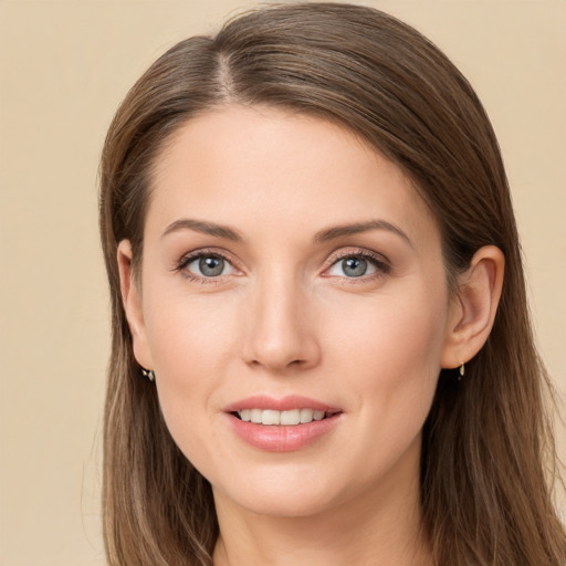 Joyful white young-adult female with long  brown hair and grey eyes