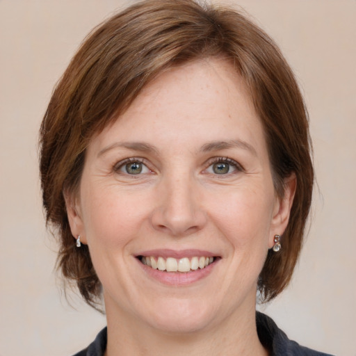 Joyful white adult female with medium  brown hair and blue eyes