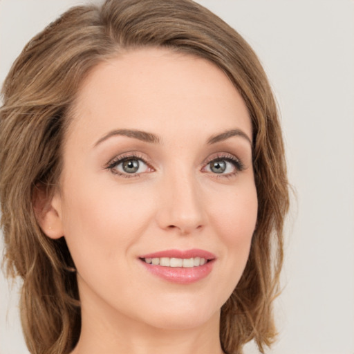 Joyful white young-adult female with long  brown hair and green eyes