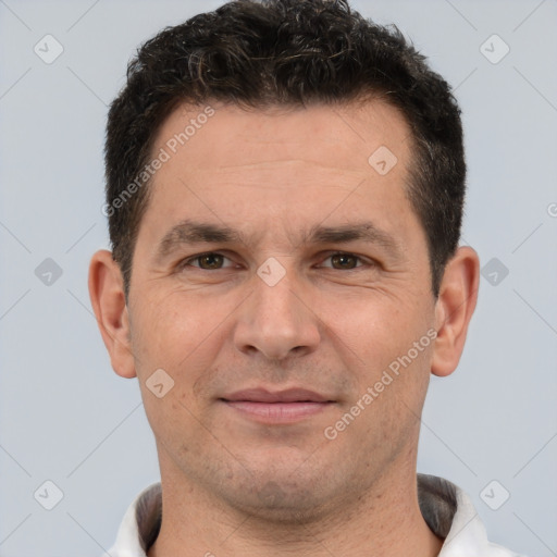 Joyful white adult male with short  brown hair and brown eyes