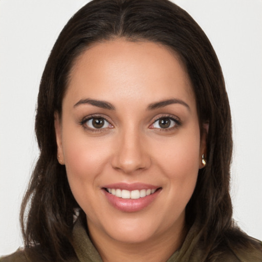 Joyful white young-adult female with long  brown hair and brown eyes