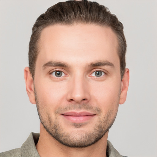 Joyful white young-adult male with short  brown hair and grey eyes