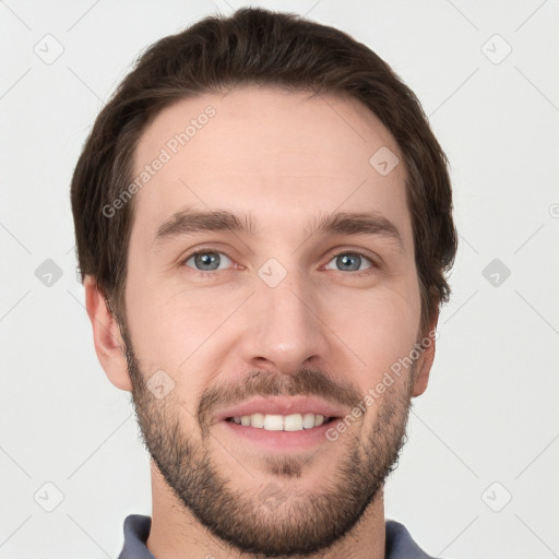 Joyful white young-adult male with short  brown hair and grey eyes