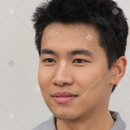 Joyful asian young-adult male with short  black hair and brown eyes