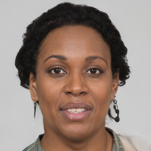 Joyful black adult female with short  brown hair and brown eyes