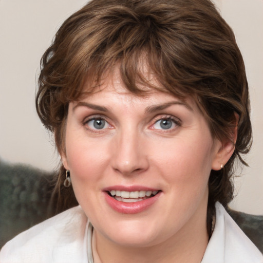 Joyful white young-adult female with medium  brown hair and blue eyes