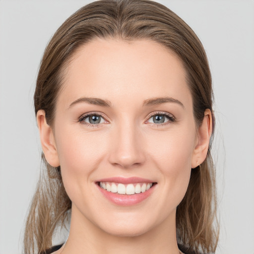 Joyful white young-adult female with long  brown hair and grey eyes