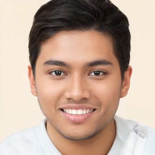 Joyful latino young-adult male with short  brown hair and brown eyes