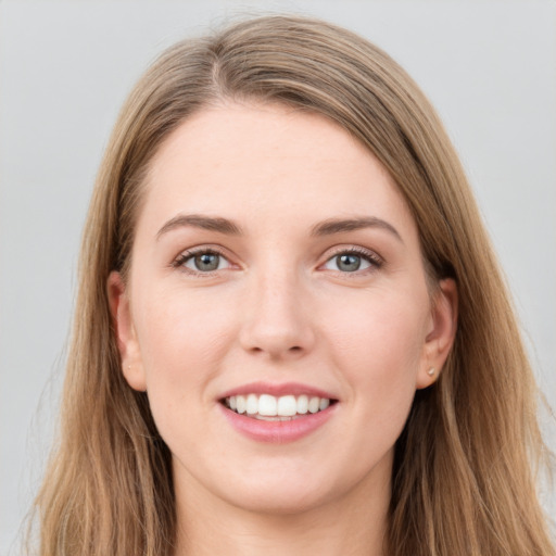 Joyful white young-adult female with long  brown hair and grey eyes