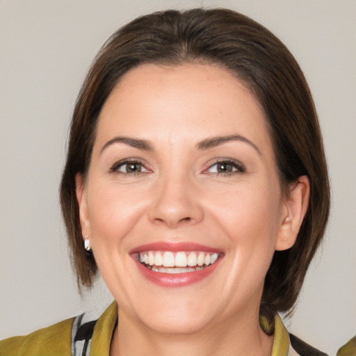 Joyful white young-adult female with medium  brown hair and brown eyes