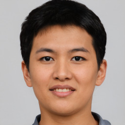 Joyful asian young-adult male with short  black hair and brown eyes