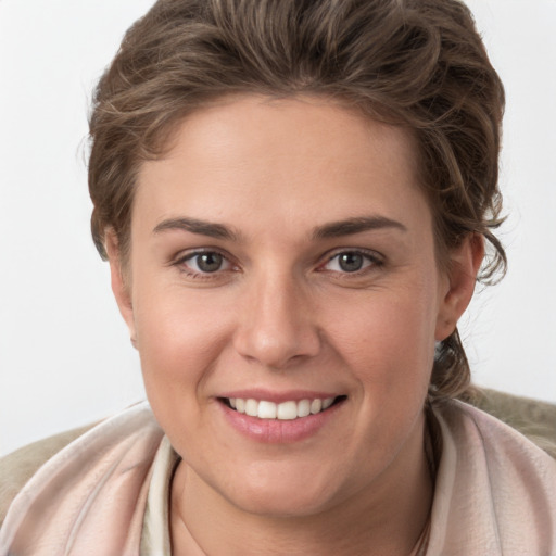 Joyful white young-adult female with short  brown hair and grey eyes